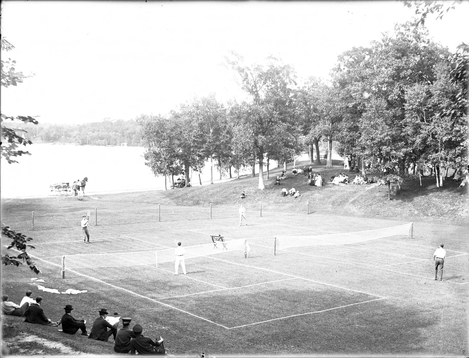Grass-court tennis matches in a historical photograph.