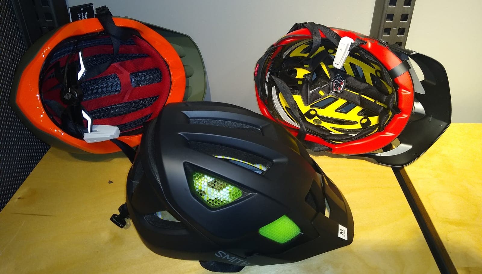 Three bicycle helmets displayed together.
